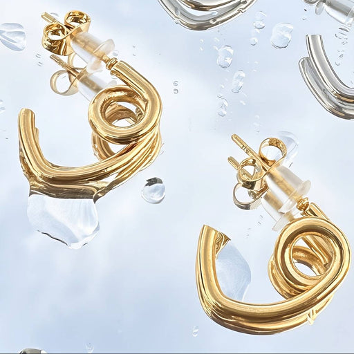 Gold spiral earrings on a clear background