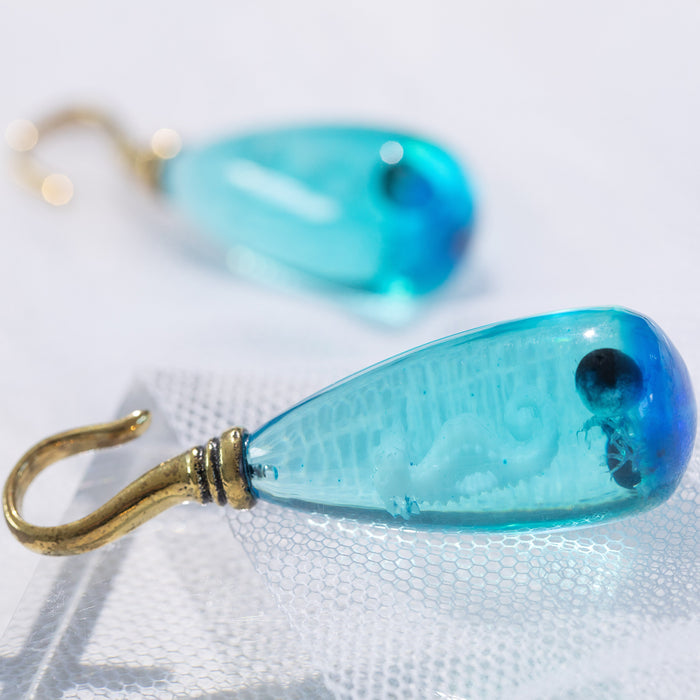 Sea Horse Epoxy Ear Hanger – Blue Epoxy Drop with White Seahorse and Black Pearl on Brass Hanger with tulle background