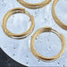 Gold earring hoops with mirror background and water droplets
