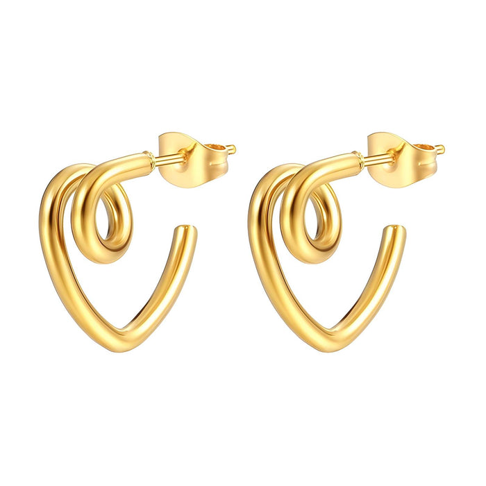 Gold hoop earrings on a textured surface