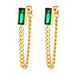 Gold chain earrings with green gemstones on a white background
