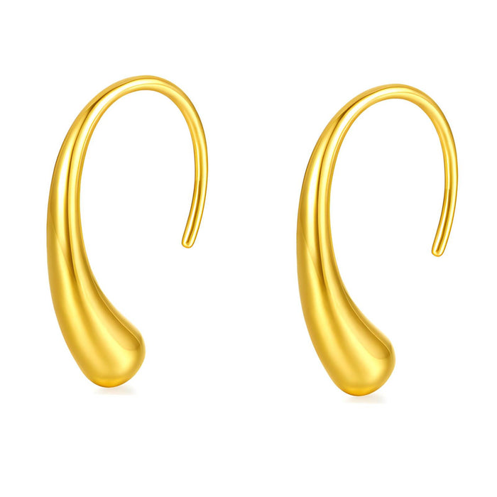 Pair of gold drop earrings on white background