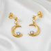 Gold earrings with moon designs and clear stones on a white background