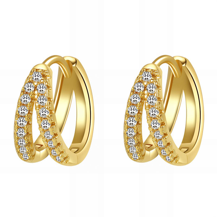 Gold hoop earrings with clear gemstones on a white background