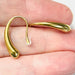 gold drop earrings on hand