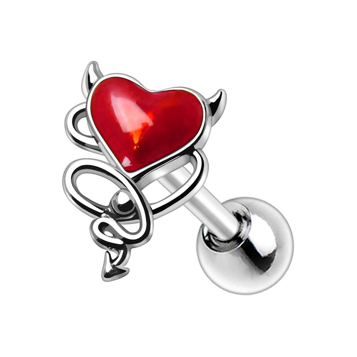 Piercing with a red heart and silver devil wings on a white background