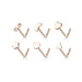 Set of rose gold nose rings with various shapes on a white background
