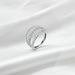 Silver ring with diamonds on a white fabric background