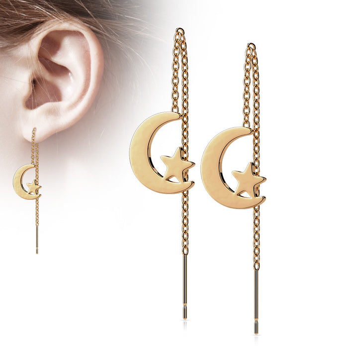 Rose Gold earrings with moon and star designs hanging from an ear.
