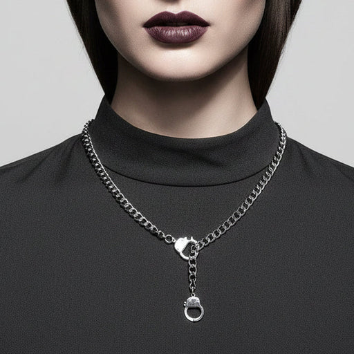 Silver chain necklace on a mannequin with a gray background