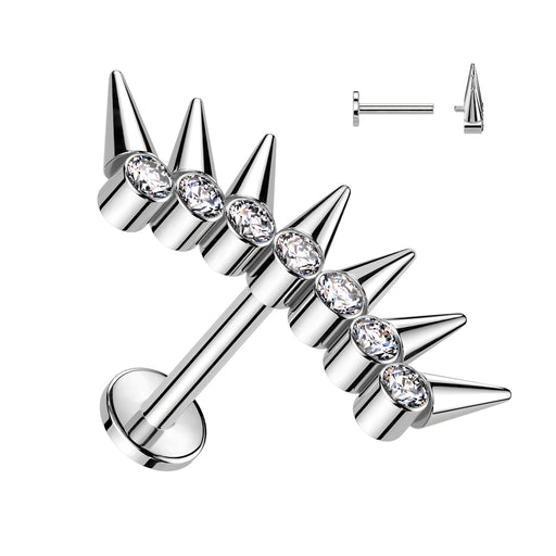 Silver spike earrings with clear gemstones on a white background