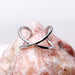 Cross Faker Ear Cuff on pink crystal background